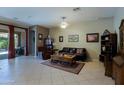 Spacious living room featuring neutral paint, tile floors, and access to the backyard at 4609 W Challenger Trl, New River, AZ 85087