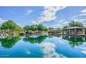 Scenic community pond reflecting the surrounding landscaping and blue sky at 4609 W Challenger Trl, New River, AZ 85087