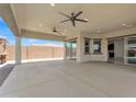 Large covered patio with ceiling fans, recessed lighting, and seamless access to the backyard and kitchen at 4866 N 185-Th Dr, Goodyear, AZ 85395