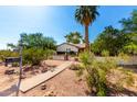 This home showcases a spacious front yard, a sidewalk leading to the front door, and a secure brick and stucco fence at 5744 E Oak St, Scottsdale, AZ 85257