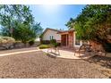 Beautiful front yard with patio seating, featuring a brick facade and meticulous landscaping, complete with an American flag at 5744 E Oak St, Scottsdale, AZ 85257
