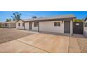 Long driveway leading to the house with ample parking space and rock landscaping at 6140 W Berkeley Rd, Phoenix, AZ 85035