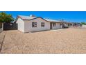 Side view of the house featuring gravel landscaping and well-maintained exterior at 6140 W Berkeley Rd, Phoenix, AZ 85035