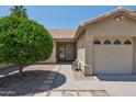 Charming front exterior featuring a small green tree and a covered entrance to the home at 6645 E Preston St, Mesa, AZ 85215
