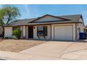 Cozy home featuring a well-kept yard, desert landscaping, and a convenient two-car garage at 733 E Halifax St, Mesa, AZ 85203