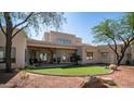 Large backyard with artificial turf, patio, and desert landscaping at 8540 E Mcdowell Rd # 116, Mesa, AZ 85207