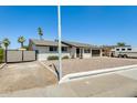 White brick single-story home featuring low maintenance landscaping and a RV gate at 9214 N 54Th Ave, Glendale, AZ 85302