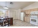 Kitchen with tile floors, dining table, and white appliances at 10305 E Dragoon Ave, Mesa, AZ 85208