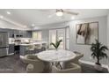 Bright open-concept kitchen and dining area with stainless steel appliances and a marble table at 1055 E Ingram St, Mesa, AZ 85203
