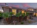 Charming single-story home featuring a well-kept yard with small palm trees, brick accents, and a tile roof at 17866 W Lilac St, Goodyear, AZ 85338