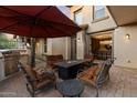 Stylish outdoor patio featuring a fire pit, comfortable seating, and a built-in grill for entertaining at 17903 N 93Rd Way, Scottsdale, AZ 85255