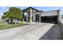 View of modern-style home from the driveway, with concrete paving and artificial lawn at 1807 E Campbell Ave, Phoenix, AZ 85016