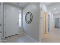 Bright foyer with tile flooring, a stylish mirror, and views into adjoining rooms at 21120 E Creekside Dr, Queen Creek, AZ 85142