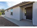 Inviting front entrance with a solid door and a covered porch, offering curb appeal at 21120 E Creekside Dr, Queen Creek, AZ 85142