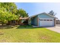 Charming single-story home with a well-maintained lawn, mature trees, and a two car garage at 2161 E Harmony Cir, Mesa, AZ 85204