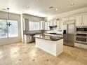 Spacious kitchen featuring white cabinetry, granite countertops, stainless steel appliances, and tile backsplash at 22903 N 39Th Ter, Phoenix, AZ 85050