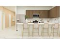 Modern kitchen featuring stainless steel appliances, white countertops, and bar seating at 23089 E Saddle Way, Queen Creek, AZ 85142