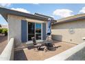 Private patio featuring comfortable seating, a table with umbrella, and a paved brick surface at 26247 W Lone Cactus Dr, Buckeye, AZ 85396
