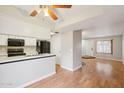 Well-lit kitchen with white cabinets, modern appliances, and an open view to the living room at 2815 N 52Nd St # 3, Phoenix, AZ 85008