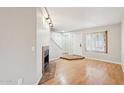 Inviting living room features a cozy fireplace, wood floors, and a bright window at 2815 N 52Nd St # 3, Phoenix, AZ 85008