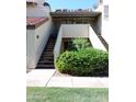 Condo exterior featuring a tidy garden, neutral colors, and easy access stairs at 30 E Brown Rd # 2113, Mesa, AZ 85201