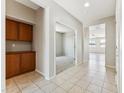 Spacious hallway with tile flooring, storage cabinets, and views into the living areas of the home at 3310 W Chambers St, Phoenix, AZ 85041