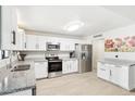 Modern kitchen featuring white cabinets, stainless steel appliances, and granite countertops, perfect for cooking and entertaining at 3410 E Everett Dr, Phoenix, AZ 85032