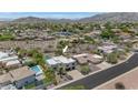 An aerial view of the home showcasing the pool, landscaping, and surrounding neighborhood at 3611 E Ahwatukee Dr, Phoenix, AZ 85044