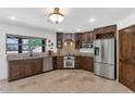 Well-equipped kitchen with stainless steel appliances, custom cabinetry and stone countertops at 3611 E Ahwatukee Dr, Phoenix, AZ 85044