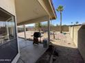 Covered patio and grill in a spacious backyard with desert landscaping and block fence at 4008 E Knox Rd, Phoenix, AZ 85044