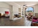 Cozy living space with fireplace, tile floors, and a view to the bedroom and outdoor patio at 4015 N 78Th St # 135, Scottsdale, AZ 85251