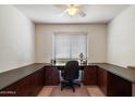 Home office with wrap around desk and dark brown cabinets with natural light and neutral colors at 4015 N 78Th St # 135, Scottsdale, AZ 85251