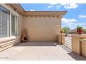 Stylish outdoor patio featuring sleek concrete flooring and a decorative chimney at 42726 N Livingstone Way, Anthem, AZ 85086