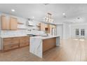 Bright and airy kitchen with marble countertops, wood cabinets, and stainless steel appliances and tiled backsplash at 4400 N 20Th St, Phoenix, AZ 85016
