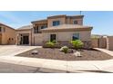 Beautiful home showcasing detailed stonework, a tile roof, and meticulous desert landscaping at 4423 W Lodge Dr, Laveen, AZ 85339