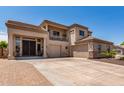 Elegant home featuring a grand entrance, two garages, and a meticulously maintained front yard at 4423 W Lodge Dr, Laveen, AZ 85339