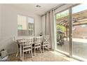 Bright dining area with tile floors, access to the back yard, and modern decor at 4807 W St Anne Ave, Laveen, AZ 85339