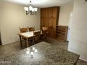 Traditional dining area includes wood furniture, ample lighting and a seamless flow to the kitchen at 564 N Santa Anna St, Mesa, AZ 85201
