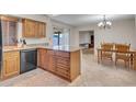 Inviting eat-in kitchen with an island, granite countertops, and a modern chandelier at 564 N Santa Anna St, Mesa, AZ 85201