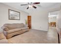 Cozy living room offering tile floors and a comfortable sofa near the dining room at 564 N Santa Anna St, Mesa, AZ 85201