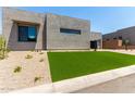 Modern home featuring desert landscaping with an artificial lawn at 5744 E Lowden Rd, Cave Creek, AZ 85331