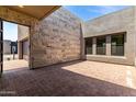 Spacious outdoor living area featuring brick flooring and access to the home's interior at 5744 E Lowden Rd, Cave Creek, AZ 85331