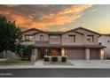 Gorgeous two-story home featuring well manicured landscaping, a two car garage, and beautiful desert sunset skies at 7156 S Forest Ave, Gilbert, AZ 85298