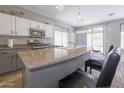 Bright kitchen features a large island, stainless steel appliances, and stylish pendant lighting at 7227 E Northridge St, Mesa, AZ 85207