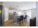 This kitchen features stainless steel appliances, an island with barstool seating, and modern lighting fixtures at 7227 E Northridge St, Mesa, AZ 85207