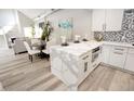 Open-concept kitchen with island seating, marble counters and stainless appliances at 7840 N 7Th St # 15, Phoenix, AZ 85020