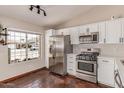 Bright kitchen featuring stainless steel appliances, white cabinets, and a window view at 925 W Hudson Way, Gilbert, AZ 85233