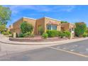 Inviting corner lot home with lush landscaping, flowers, and brick accents showcasing desert charm at 1040 E Clinton St, Phoenix, AZ 85020