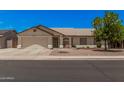 Charming single-story home featuring a well-maintained front yard, two-car garage, and inviting curb appeal at 10852 E Contessa St, Mesa, AZ 85207