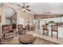 Spacious living area with tile flooring, ceiling fan and seamlessly connecting to the open kitchen and dining areas at 10852 E Contessa St, Mesa, AZ 85207